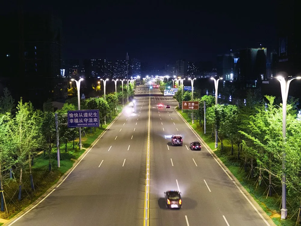 Bridge and avenue lit by LED street lights at night